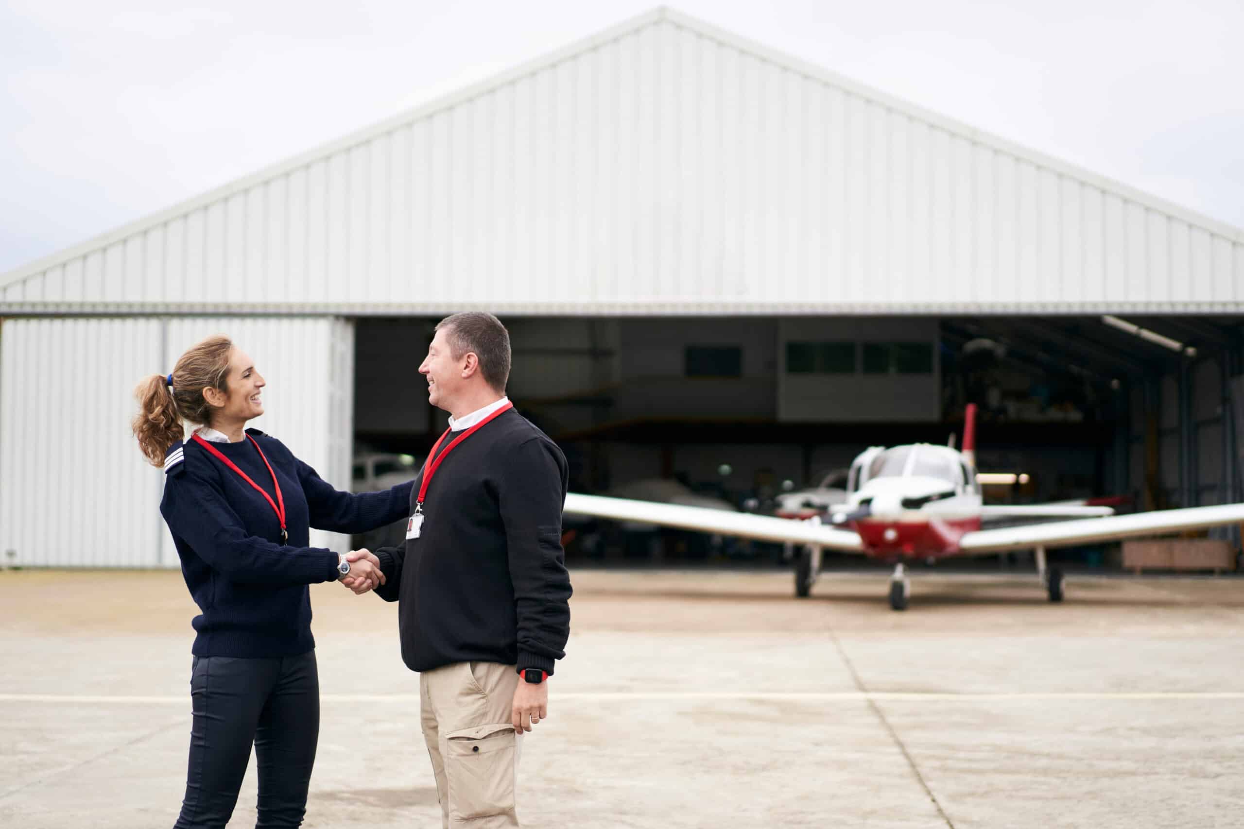 Female flight instructor congratulating her student on their first flight.
